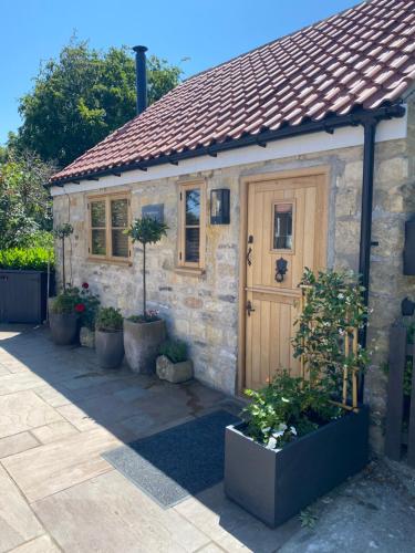 a small stone cottage with a wooden door at Cornerstone House in Pickering