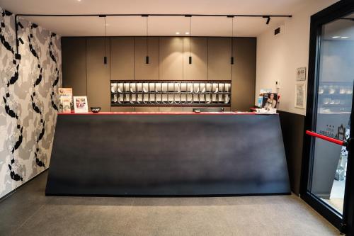 a bar in a restaurant with a counter top at Hotel Astoria in Ravenna