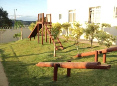 a playground with a slide in the grass at Betim paraíso in Betim