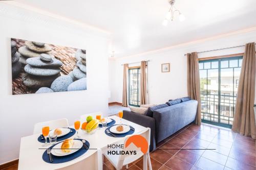 a living room with a couch and a table with food at #020 Olhos d'Água with Shared Pool, Heated Floor in Albufeira