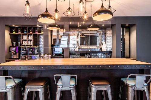 a bar at a restaurant with stools at Premier Inn Passau Weisser Hase in Passau