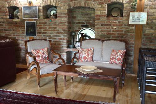 a living room with a couch and two chairs and a table at Green Hills Apartment in Sarajevo