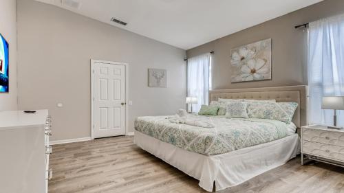a white bedroom with a bed and a window at 8122spd - Dream Villa In Windsor Palms in Kissimmee