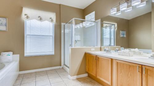 a bathroom with a sink and a shower and a tub at 8122spd - Dream Villa In Windsor Palms in Kissimmee