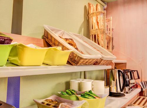 a shelf with some food and baskets on it at Hotel Inn Design Issoudun in Issoudun
