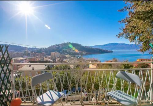 a balcony with chairs and a view of the water at Apartment With View Lake Maggiore/Laveno Mombello in Laveno
