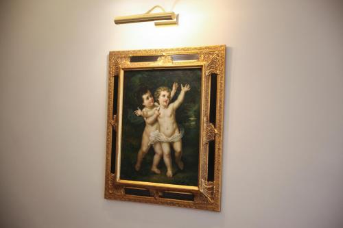 a painting of two children on a wall at Hotel Foresteria Baglio Della Luna in San Leone