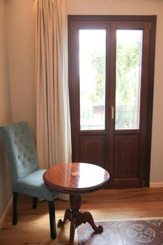 a room with a table and a chair and a window at Hotel Foresteria Baglio Della Luna in San Leone
