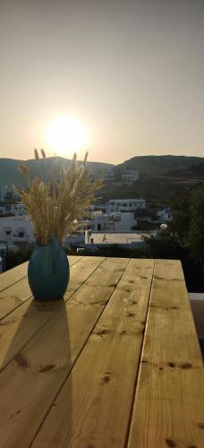 a blue vase sitting on a wooden table with a plant at Lipsi Sands in Lipsoi