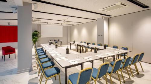 a large conference room with a long table and chairs at Hotel American Palace Eur in Rome
