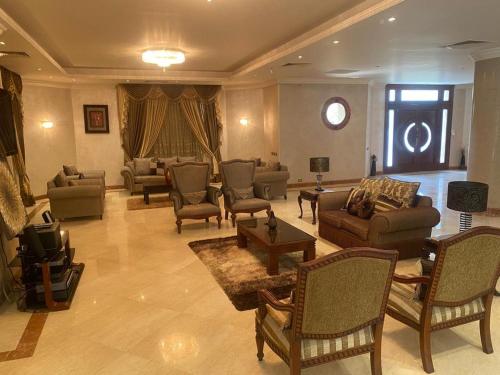 a large living room with couches and a tv at Super luxurious villa with large landscape areas in Cairo