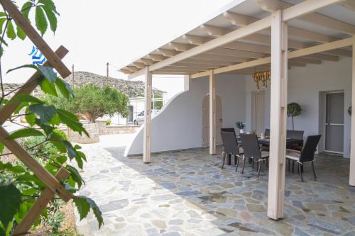 a patio with a table and chairs under a pergola at Traditional Villa Relax in Zefiría