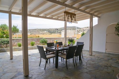 a dining room table and chairs on a patio at Traditional Villa Relax in Zefiría
