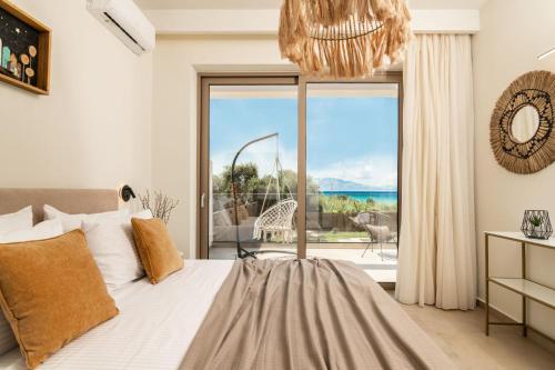 a bedroom with a bed and a large window at Aktis Elegant Villa in Alikanas