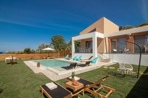 a villa with a swimming pool in a yard at Aktis Elegant Villa in Alikanas