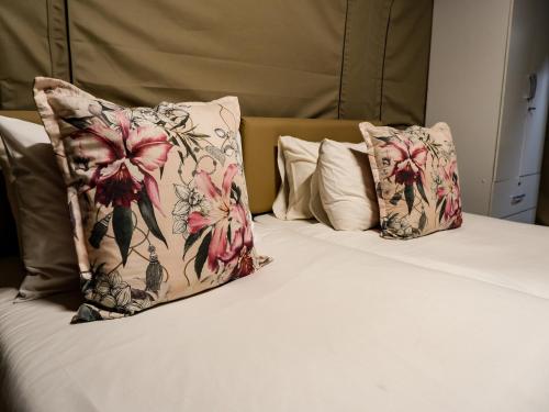 a bed with two pillows on top of it at Lions Rock Rapids - Lodge in Hazyview