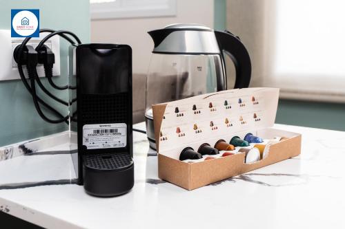a black phone sitting next to a box of chocolates at Design apartments in Netanya in Netanya