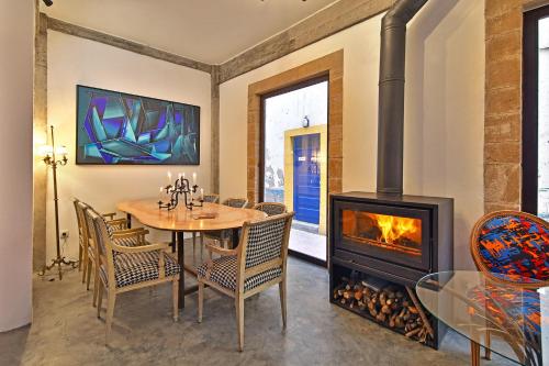 a dining room with a table and a fireplace at Riad EspritBleu - Adult Only in Essaouira