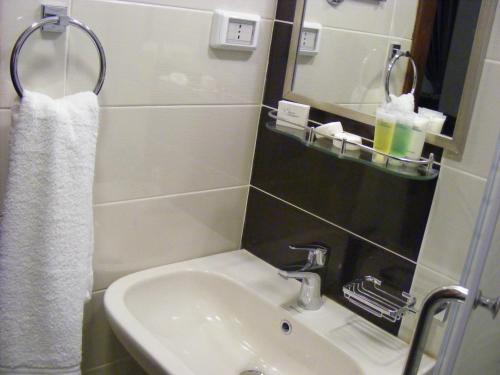 a bathroom with a sink and a mirror at Ream Hotel Amman in Amman
