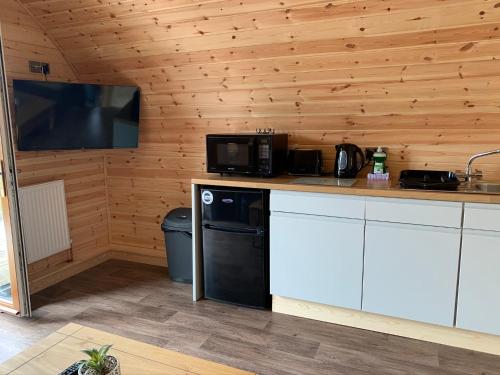 a kitchen with a counter with a microwave and a television at Pond View Pod 3 With Private Hot Tub - Fife - Loch Leven - Lomond Hills in Kelty