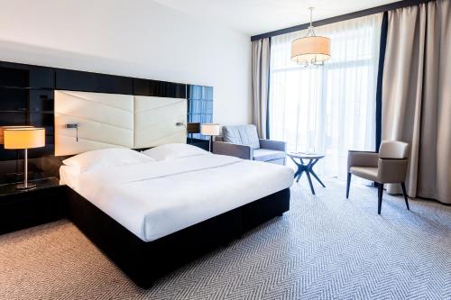 a hotel room with a bed and a desk and a chair at Diune Hotel by Zdrojowa in Kołobrzeg