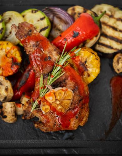 a plate of food with meat and vegetables on it at Stokker Hotel in Oradea
