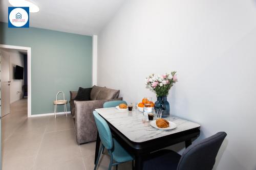 a dining room with a table and a couch at Design apartments in Netanya in Netanya