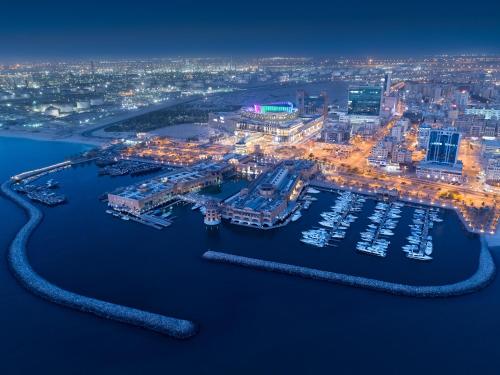 an aerial view of a harbor at night at Hyatt Regency Al Kout Mall in Kuwait