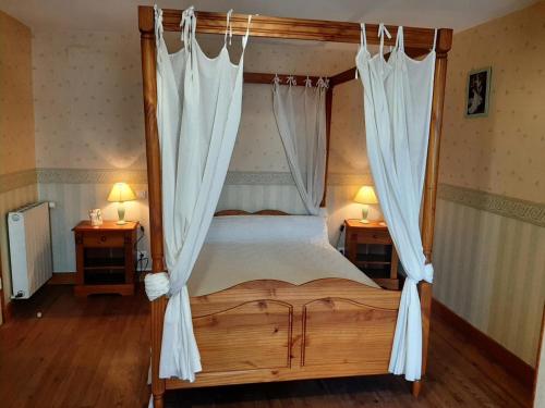 a bedroom with a canopy bed with white curtains at Gîte Bellevigne, 5 pièces, 9 personnes - FR-1-653-149 