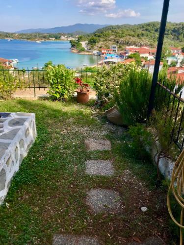 a walkway with a view of a body of water at Seaside escape in Ormos Panagias