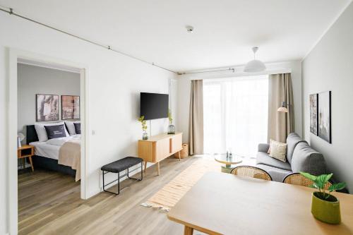 a living room with a bed and a room with a couch at Limehome Budapest Mosonyi u in Budapest
