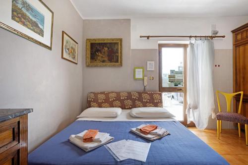 um pequeno quarto com uma cama azul com toalhas em Appartamento Arianna em Polverara