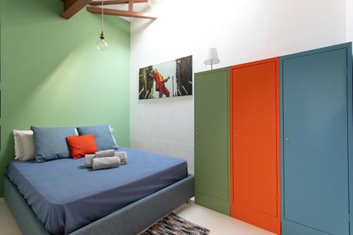 a bedroom with a bed and an orange and green cabinet at Girolamo Loft by Welchome in Venice