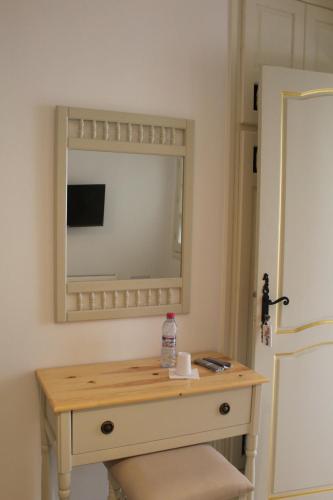a dressing table with a mirror in a room at Hotel Dar Al Madina in Mahdia