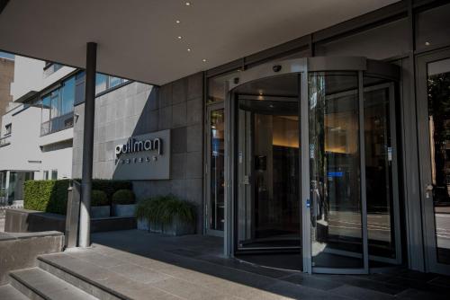 an entrance to a building with a revolving door at Pullman Eindhoven Cocagne in Eindhoven