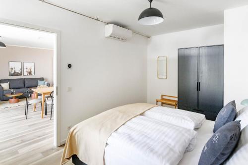 a bedroom with a bed and a living room at Limehome Budapest Mosonyi u in Budapest