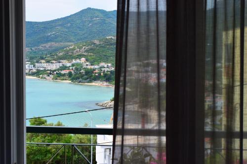 a view of a beach from a window at Aegean Dreams Villa Palio in Paleo Tsifliki