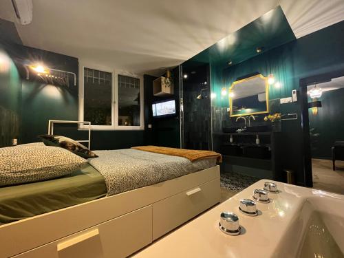 a bedroom with a bed and a tub and a sink at Le SPEAK EASY / JACUZZI ET SAUNA in Marseille