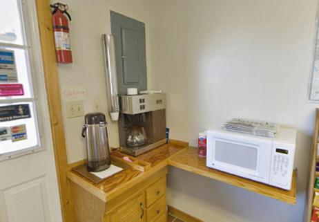 a kitchen with a counter with a microwave and a coffee maker at Americas Best Value Inn Biddeford in Biddeford