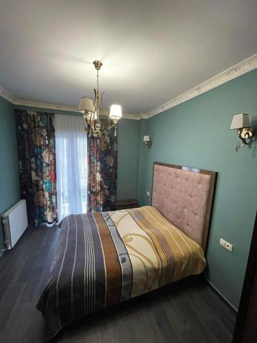 - une chambre avec un lit dans une pièce aux murs verts dans l'établissement Kvartita sofia, à Kobuleti