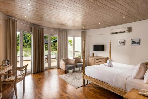 a bedroom with a large bed and a desk and chair at Ru Boutique in Kandy
