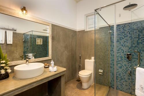 a bathroom with a sink and a toilet and a shower at Ru Boutique in Kandy