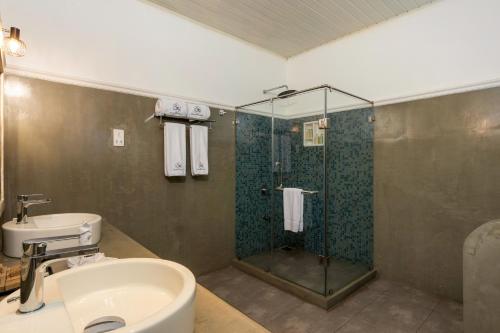 a bathroom with a shower and a sink and a sink at Ru Boutique in Kandy