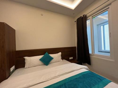 a bedroom with a large bed with a window at Hotel Yog Safari, Behind Parmarth Niketan in Rishīkesh