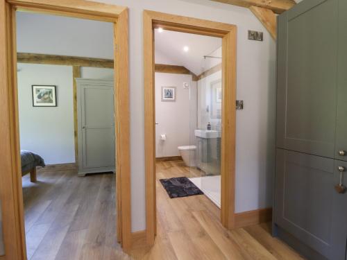 a bathroom with a mirror and a toilet in a room at Ulverston House Annex in Harrogate