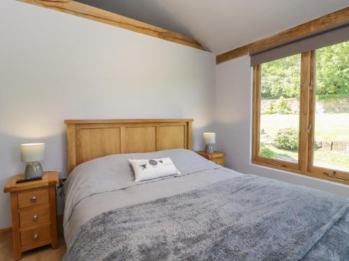 a bedroom with a bed and a window at Ulverston House Annex in Harrogate