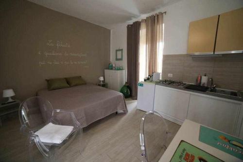 a small bedroom with a bed and a kitchen at "Le Dimore degli Artisti" RIPACANDIDA in Ripacandida