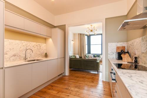 a kitchen with a sink and a counter top at King Palm Apartment at Sea View Terrace, Margate. in Kent