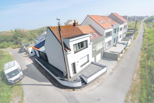 a house with a car parked in front of it at maison des dunes in Ostend