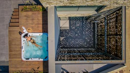 a swimming pool with a person in the water at Sunrise Beachfront Villas - Villa 1 in Paralimni